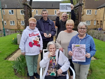 Snapenook Court residents, a family member of Robert and Cllr Michael Savage receiving Robert's award posthumously in his honour