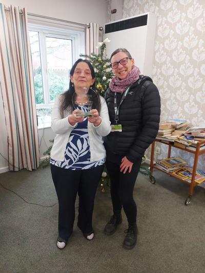 A picture of Amanda Prout being presented with her Best Edible Garden winners trophy